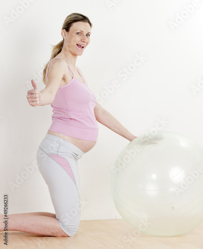 pregnant woman doing exercises with a ball