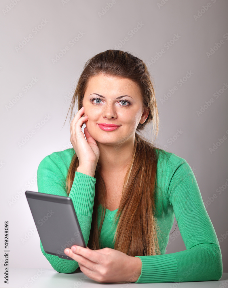 Young woman sitting on the desk with computer plane-table Young woman sitting on the desk with computer plane-table