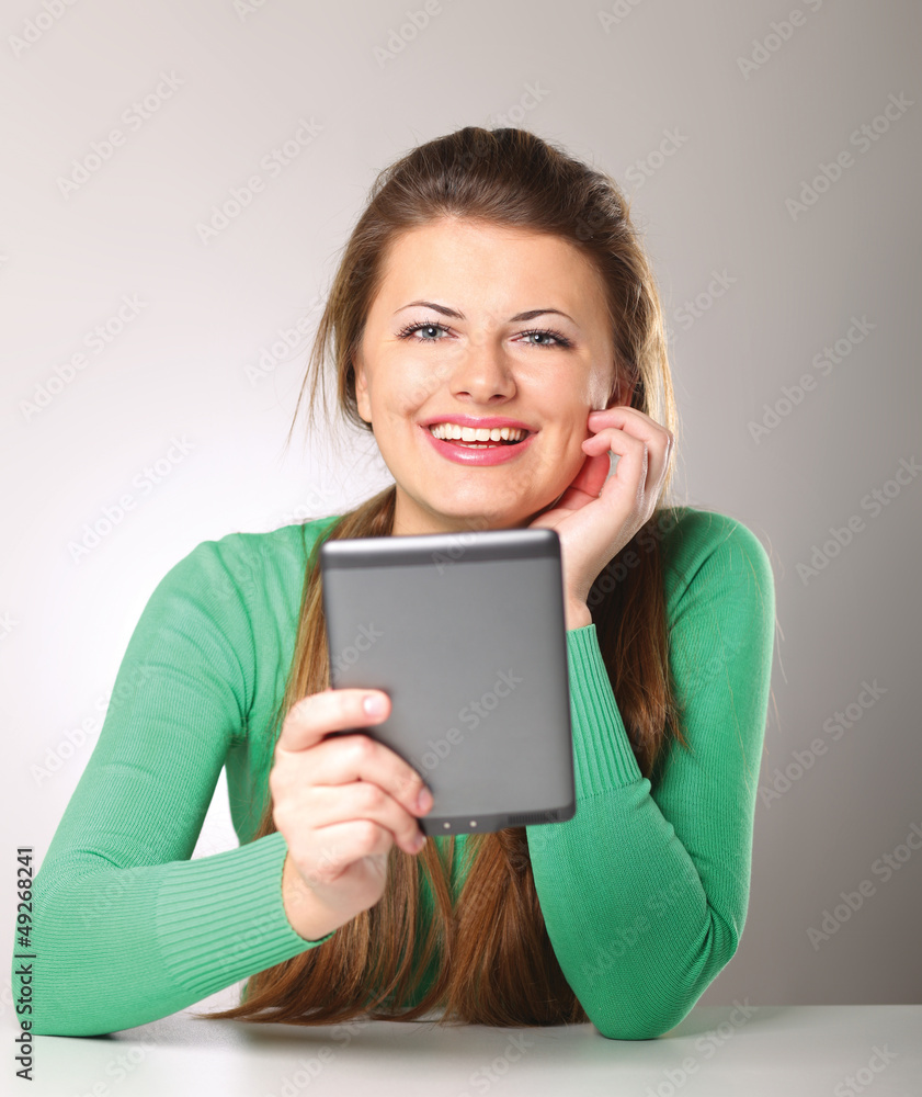 Young woman sitting and holding computer plane-table Young woman sitting and holding computer plane-table