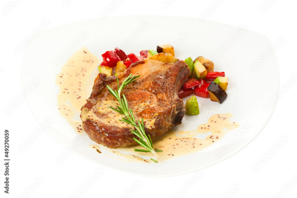 Grilled pork loin with vegetables on the plate Grilled pork loin with vegetables on the plate