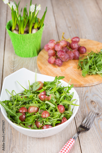 Fresh rucola salad with red grapes