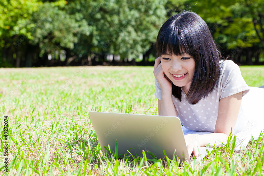 attractive asian woman using smart phone in the park attractive asian woman using smart phone in the park