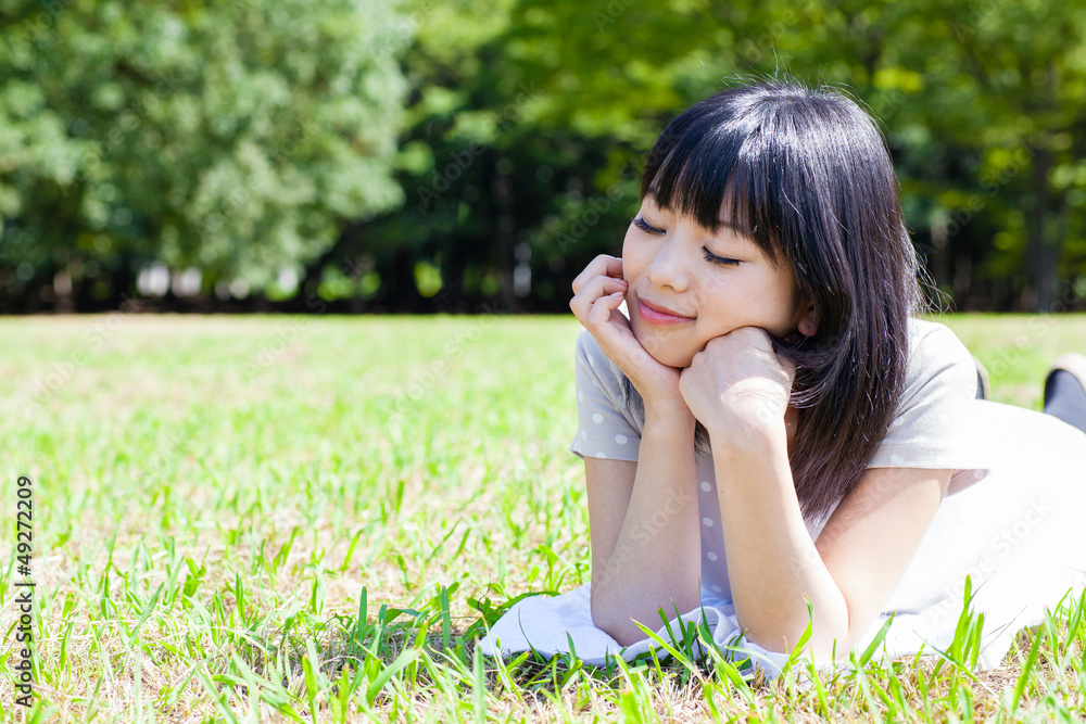 attractive asian woman relaxing in the park attractive asian woman relaxing in the park