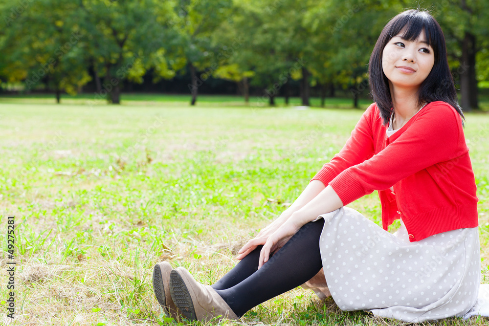 attractive asian woman relaxing in the park attractive asian woman relaxing in the park