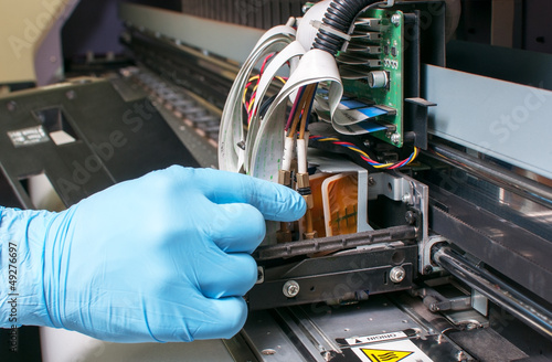 worker repairing printer
