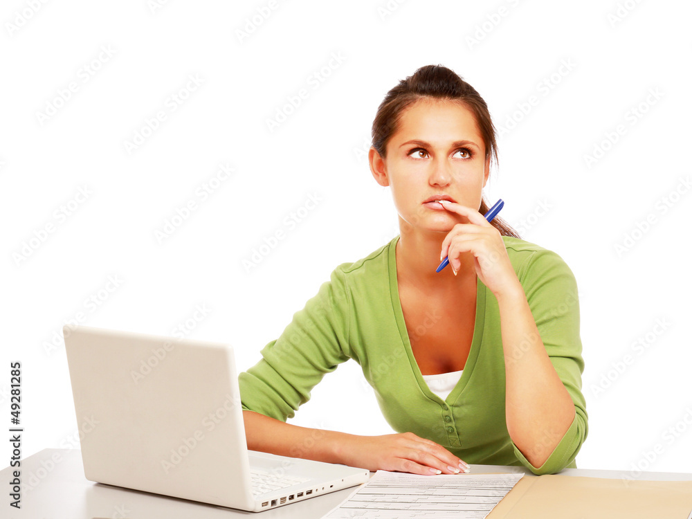 A young college girl sitting in front of a laptop, looking up A young college girl sitting in front of a laptop, looking up