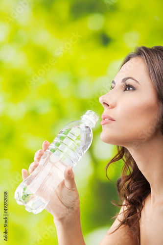 Young woman drinking water, outdoor