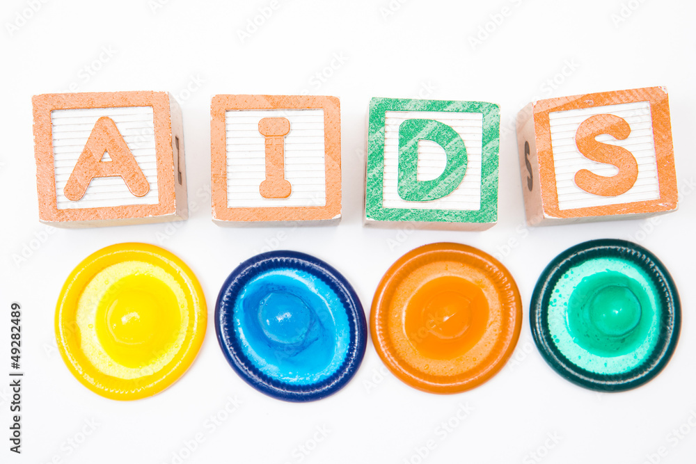 Wood blocks spelling out aids with four condoms Wood blocks spelling out aids with four condoms
