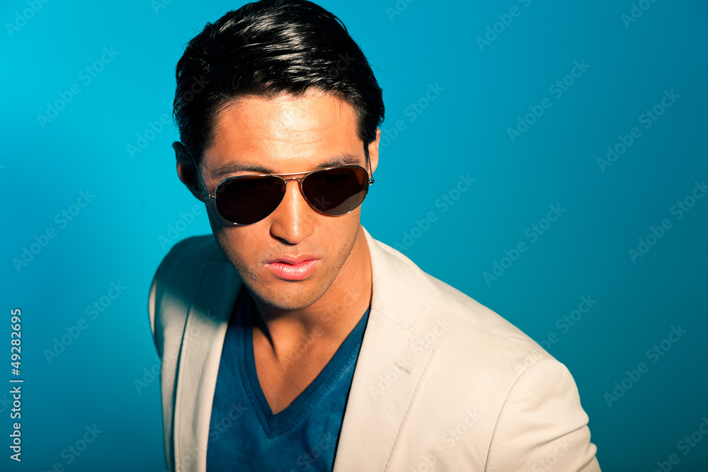 Asian man wearing suit and sunglasses. Summer fashion. Studio. Asian man wearing suit and sunglasses. Summer fashion. Studio.