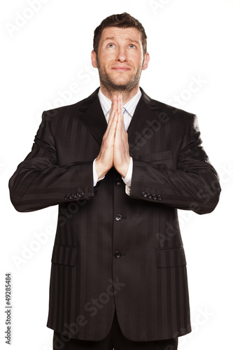 young businessman praying with his hands set in pray