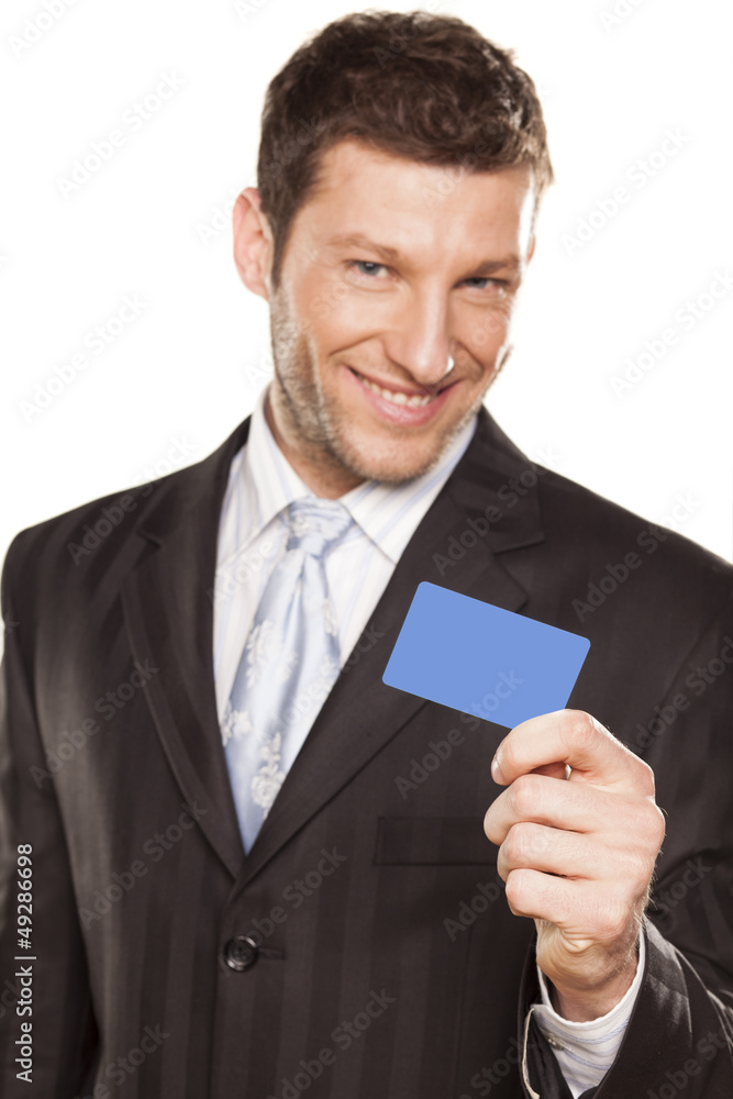 smiling handsome businessman showing a credit card smiling handsome businessman showing a credit card