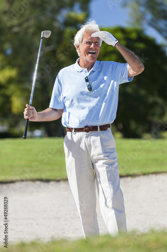 Happy Senior Man Playing Golf In Bunker