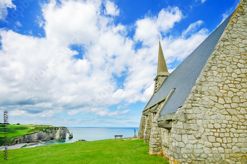 Church, Etretat beach and Aval cliff. Normandy, France.