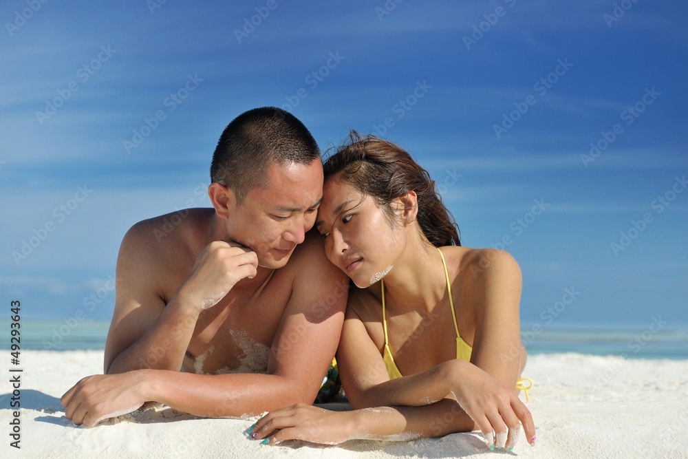 asian couple enjoying summer on beach