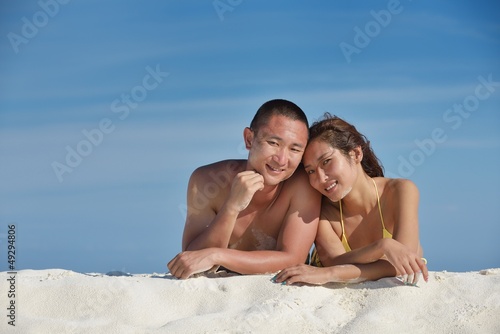 asian couple enjoying summer on beach