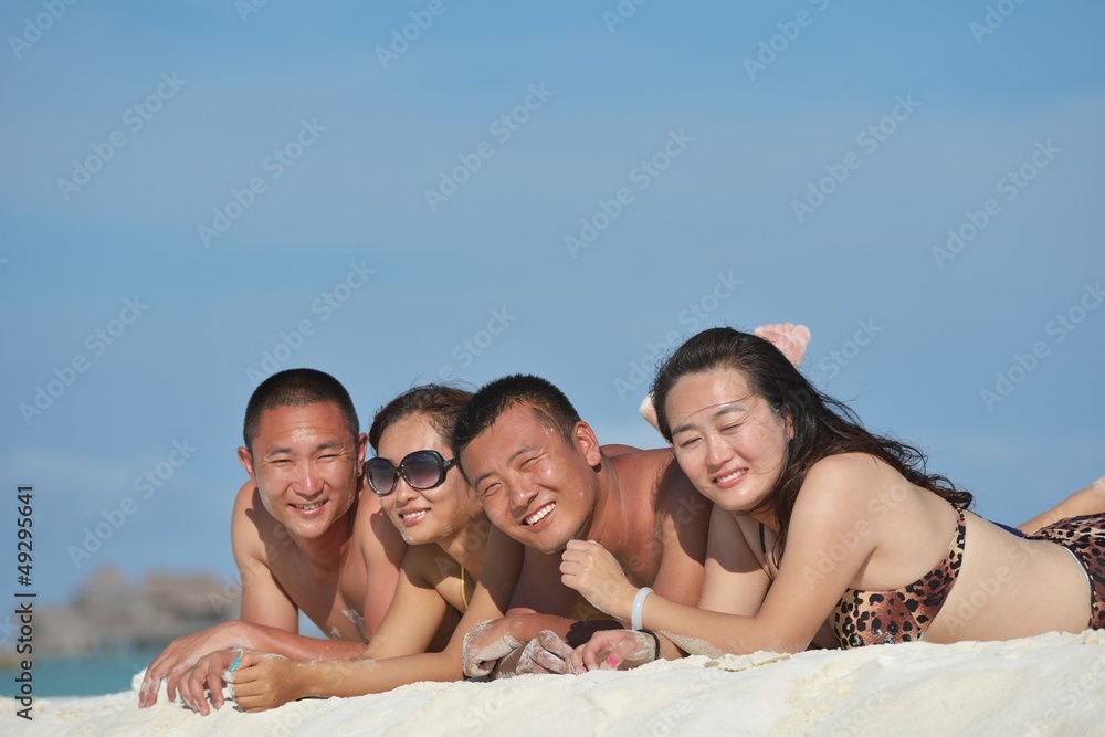 group of happy young people have fun on bach group of happy young people have fun on bach