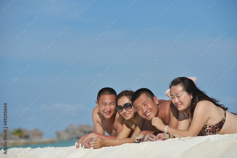 group of happy young people have fun on bach group of happy young people have fun on bach