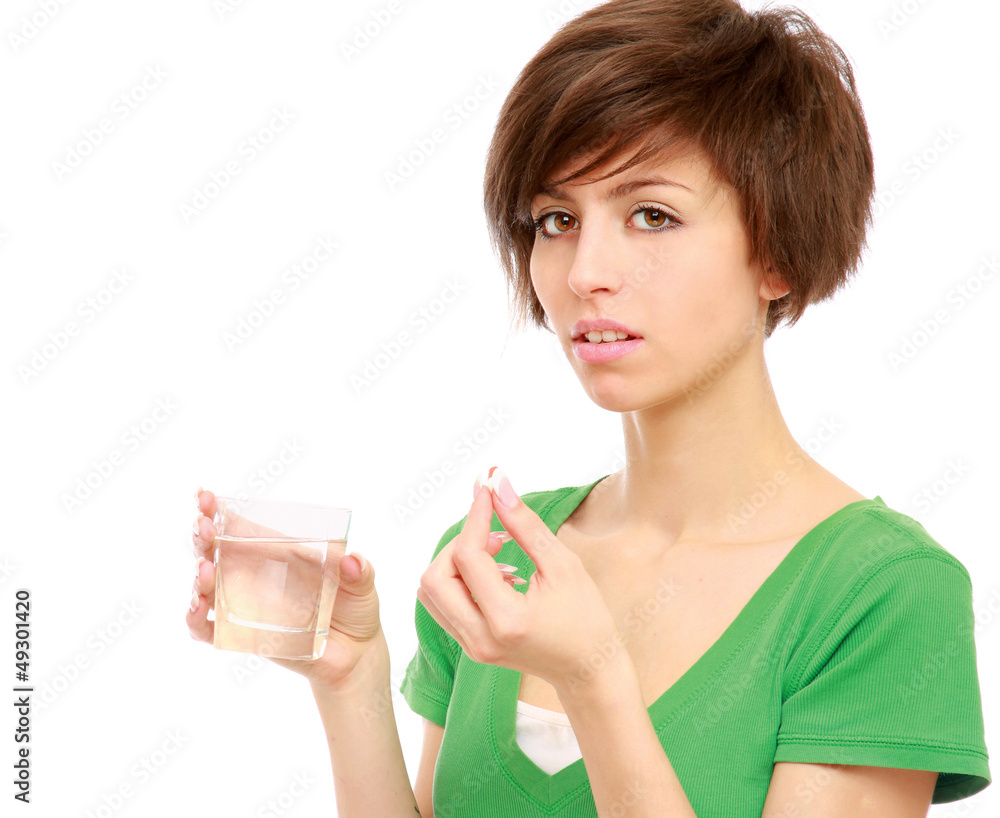 Young woman holding a pill and water, isolated on white Young woman holding a pill and water, isolated on white