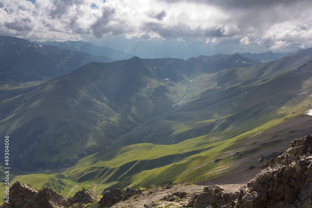 green mountain valley in a rays of sun