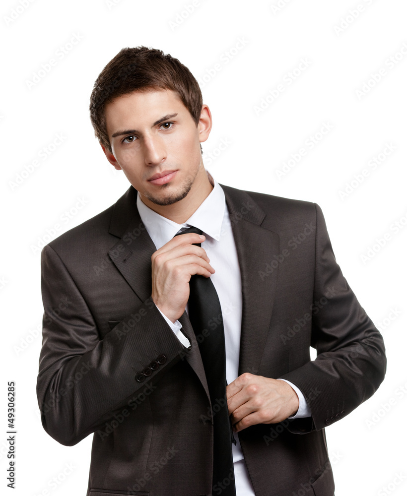 Man straightens his black tie, isolated on white Man straightens his black tie, isolated on white