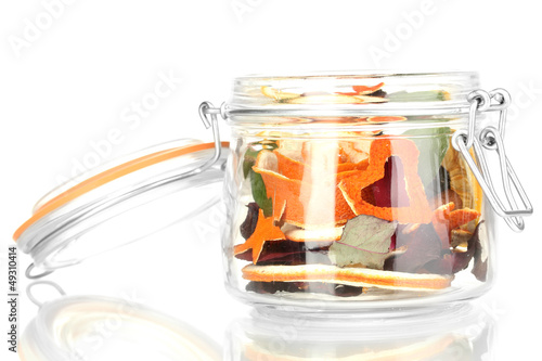 Decorative rose from dry orange peel in glass vase isolated