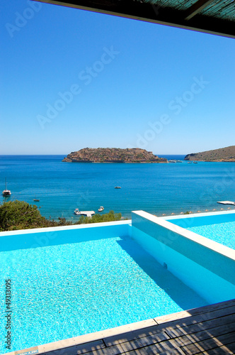 Swimming pool by luxury villa with a view on Spinalonga Island, © slava296
