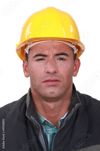 A construction worker with a weird expression.