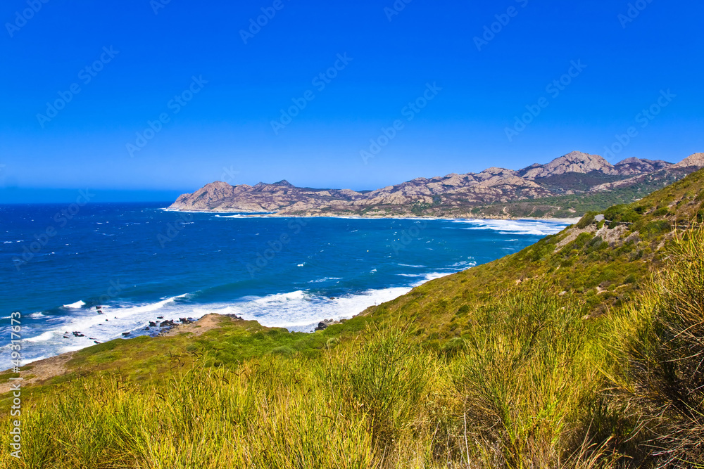 Crystal clean sea along white sand beach in island Corsica Crystal clean sea along white sand beach in island Corsica