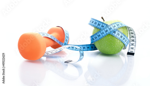 Dumbbell with apple and measure tape, isolated on white
