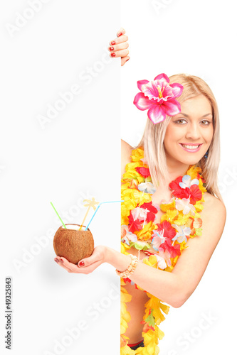 Woman dressed in a hawaiian costume holding a cocconut cocktail photo