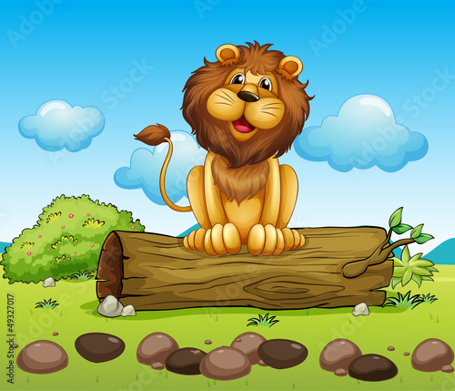 A happy lion on a trunk of a tree
