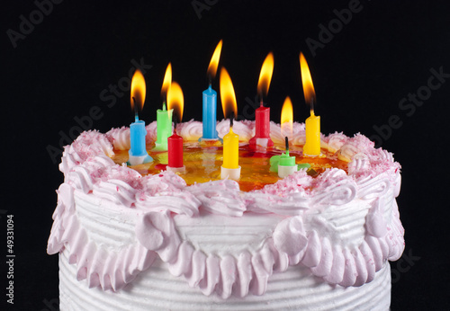 appetizing holiday cake with the light colorful candles