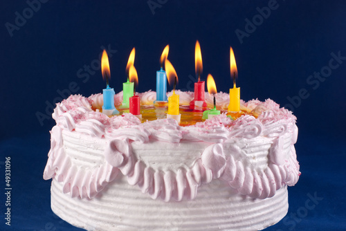 appetizing holiday cake with the light colorful candles