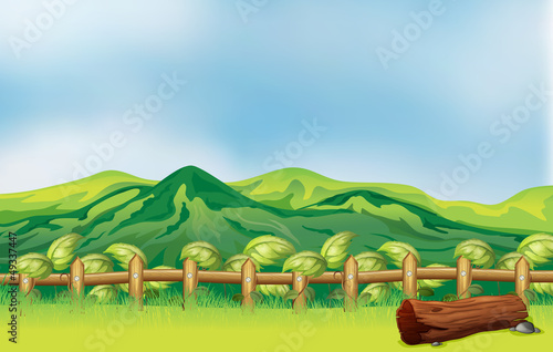 A mountain view across a wooden fence