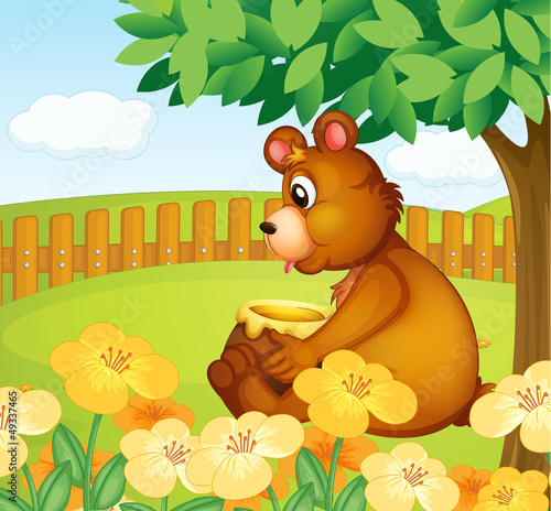 A bear sitting in a beautiful garden