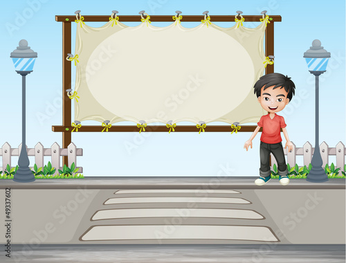 A boy standing along the road