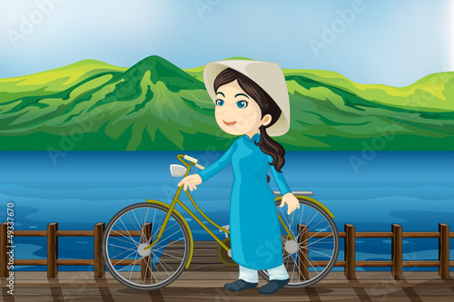 A girl with bicycle on a bench