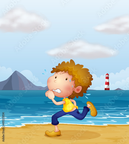 A young man jogging along the beach