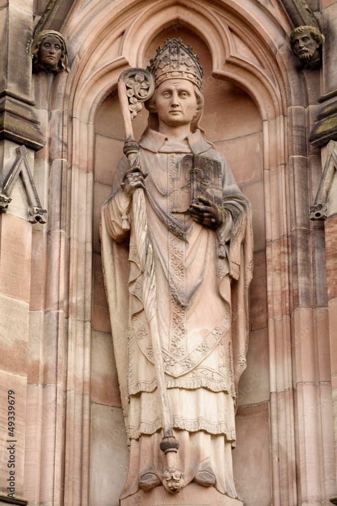 Stone sculpture of priest