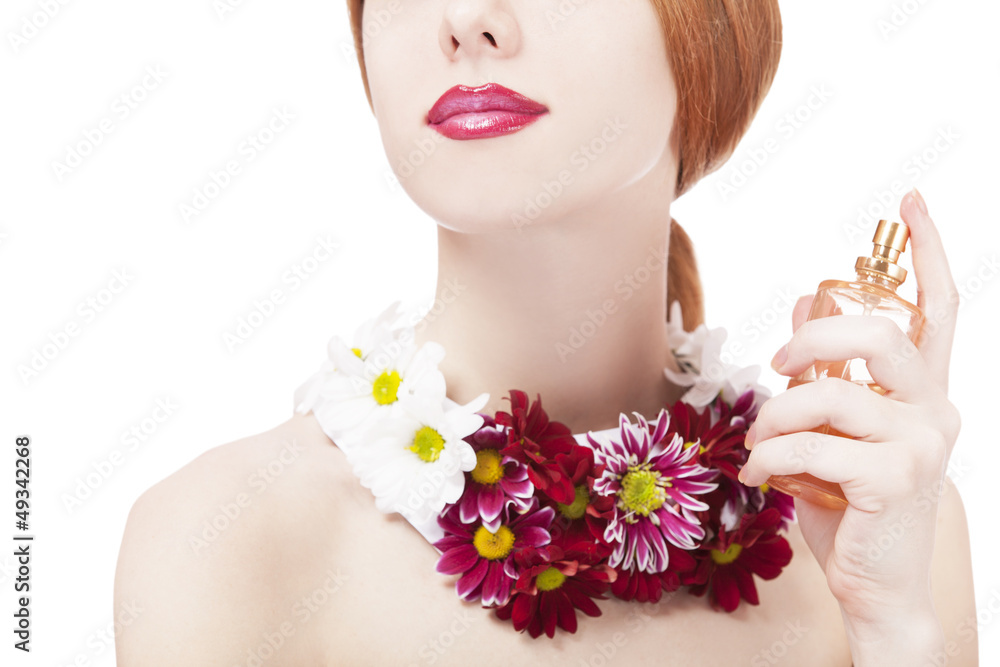 Fototapeta premium Beautiful redhead girl with flowers and perfume