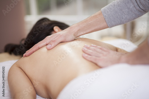 Chubby woman getting a massage at a health and beauty spa