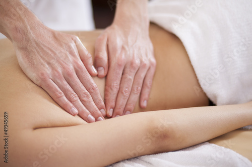 Closeup of the hands of a therapist giving a back massage