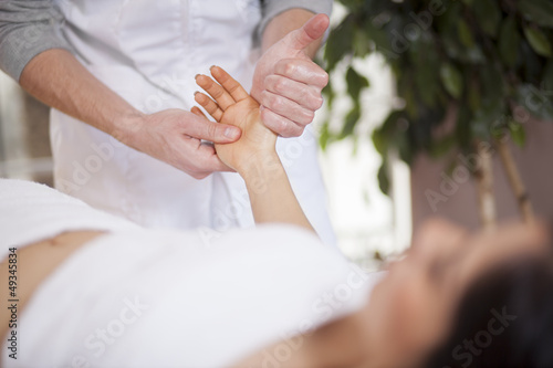 Young woman getting a hand massage at a health and beauty spa