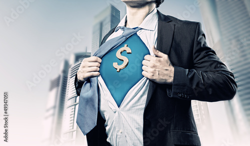 Businessman showing superman suit underneath shirt