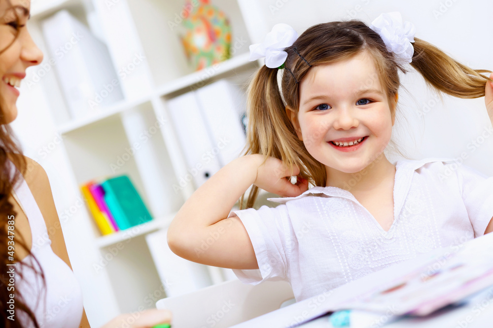 Little girl and her mother studying Little girl and her mother studying