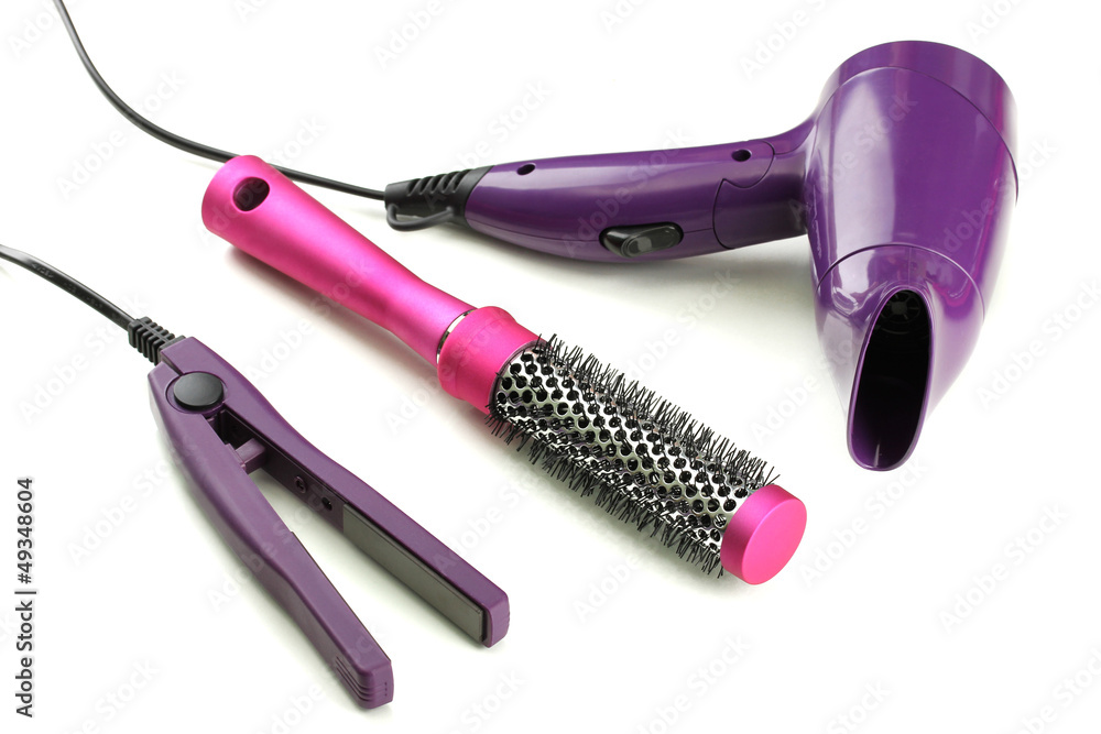 Hair dryer, straighteners and comb brush, isolated on white Hair dryer, straighteners and comb brush, isolated on white