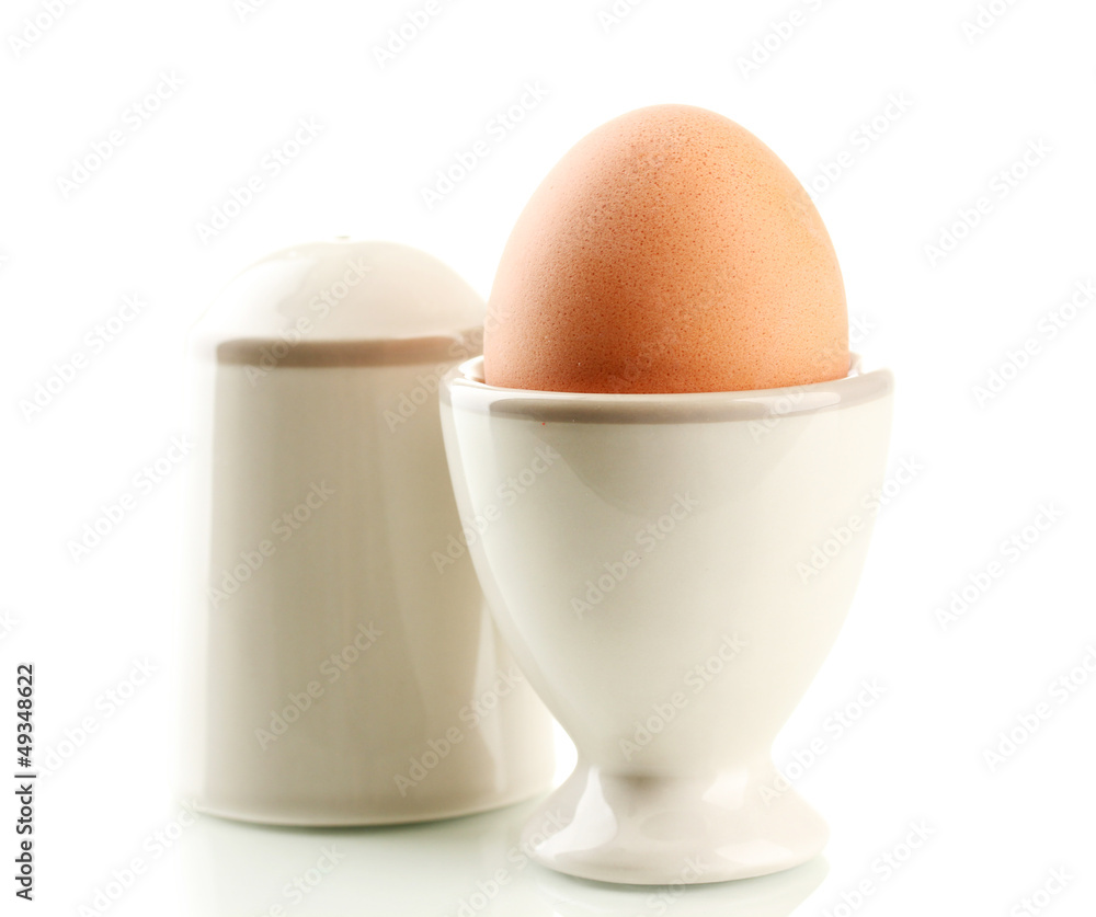 Whole boiled egg in egg cup and salt, isolated on white Whole boiled egg in egg cup and salt, isolated on white