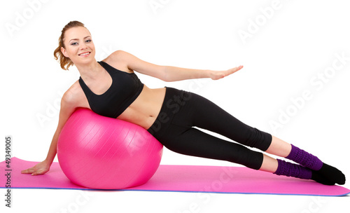 Young woman doing fitness exercises with gym ball isolated