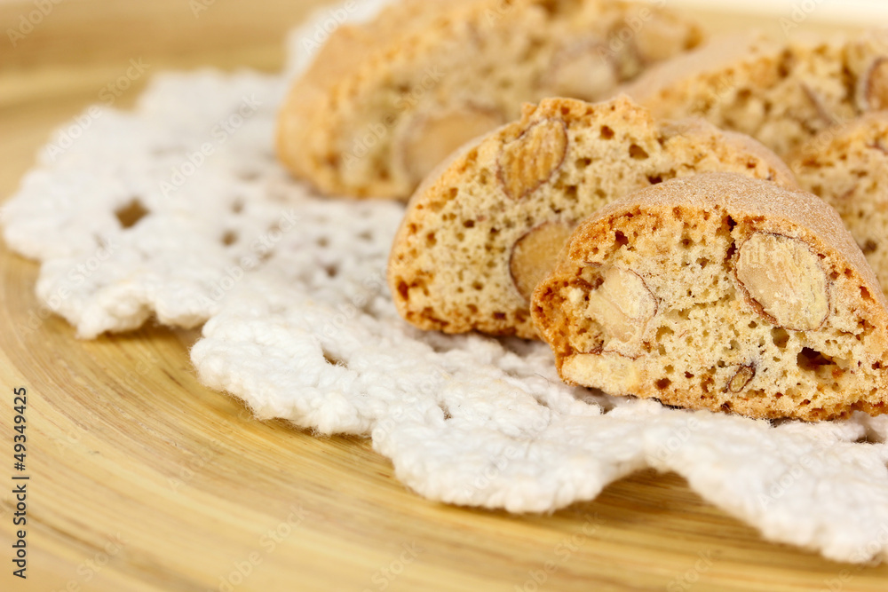 Aromatic cookies cantuccini on wooden plate close-up