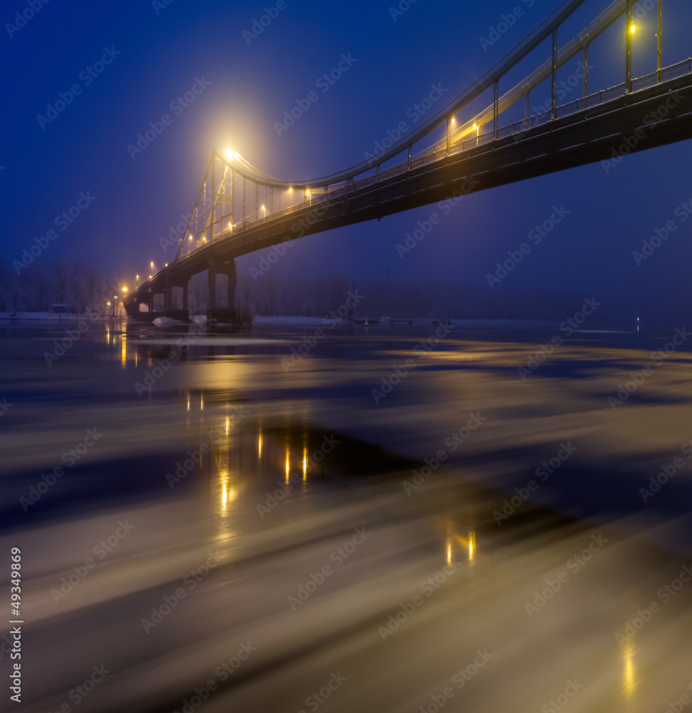 Ice is broken. Footbridge in winter Kiev.